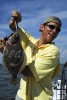 Happy angler with flounder