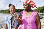 Mother and daughter with catfish