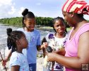Family members examine catfish