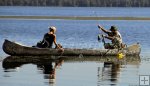 Couple catching crappie from canoe
