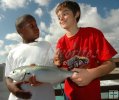 Two young fishermen with bluefish