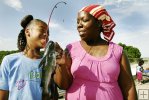 Mother and daughter with catfish