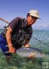Angler wading with fish